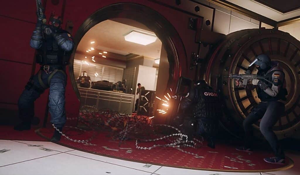 Operators breaching a bank vault surrounded by barbed wire in Rainbow Six Siege X