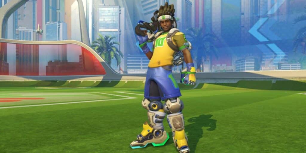 Lucio in a bright yellow and blue athletic outfit stands on a grassy field, ready for action, with a modern cityscape in the background